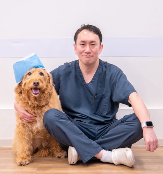 犬と並んで微笑む濱谷直幸院長